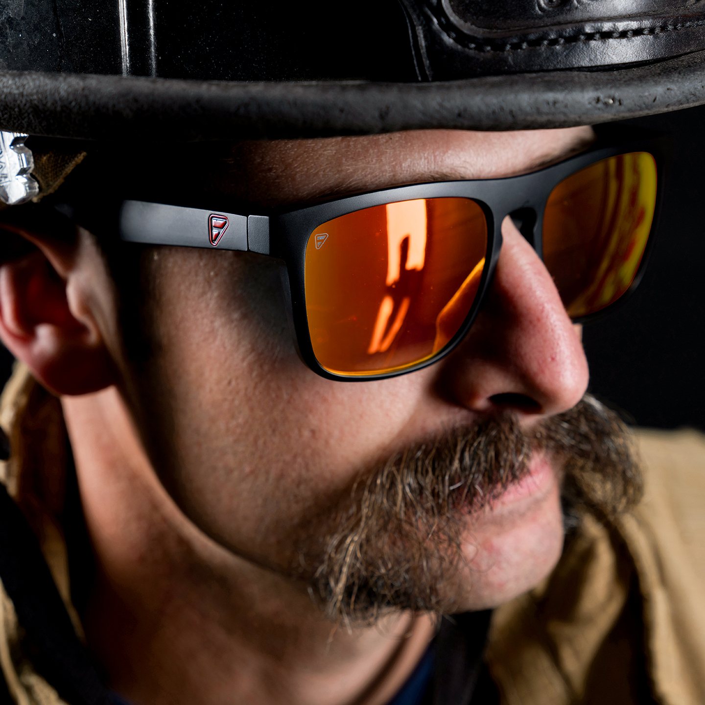 Firefighter wearing Frontline Optics sunglasses under a fire helmet
